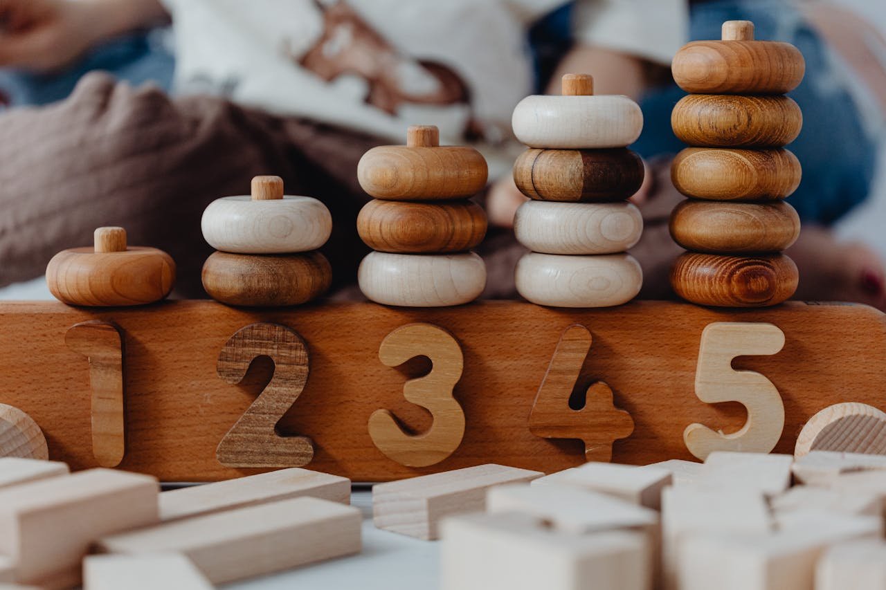Menu Close-up of wooden number stacking toy promoting creativity and learning in children.